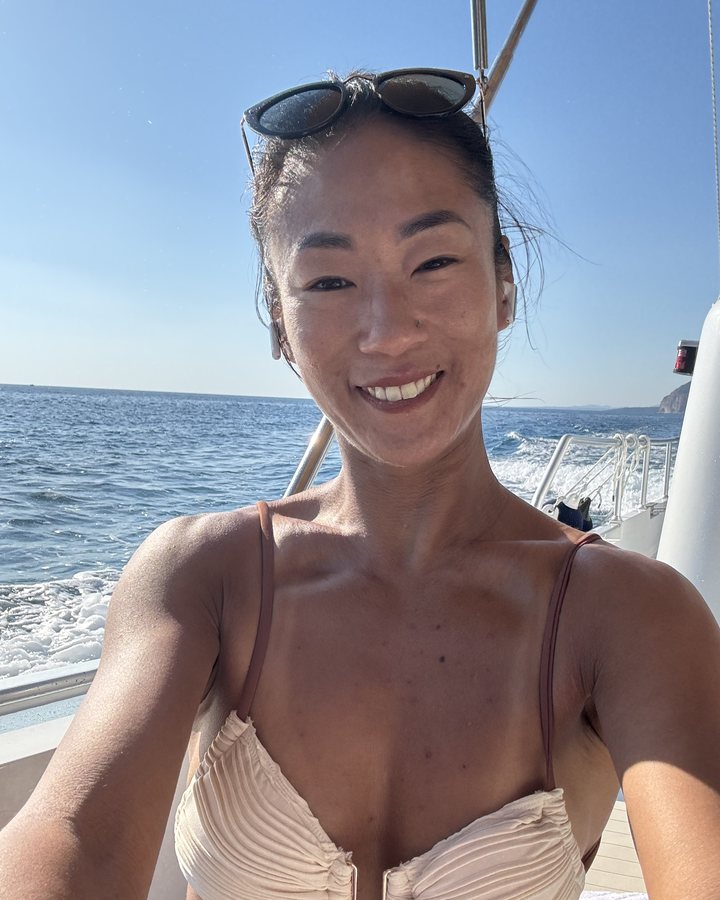 Samantha smiling on a boat